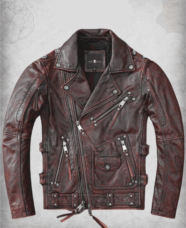 A front-view studio photograph of a distressed dark red and black biker leather jacket featuring an asymmetrical zipper, silver stud accents on the lapels, and multiple zippered utility pockets.