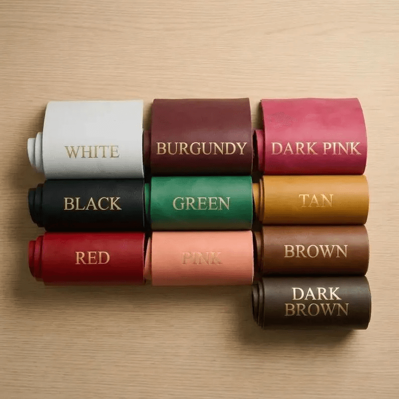 A collection of leather swatches showing ten available colors for the dog coat: White, Burgundy, Dark Pink, Black, Green, Tan, Red, Pink, Brown, and Dark Brown.