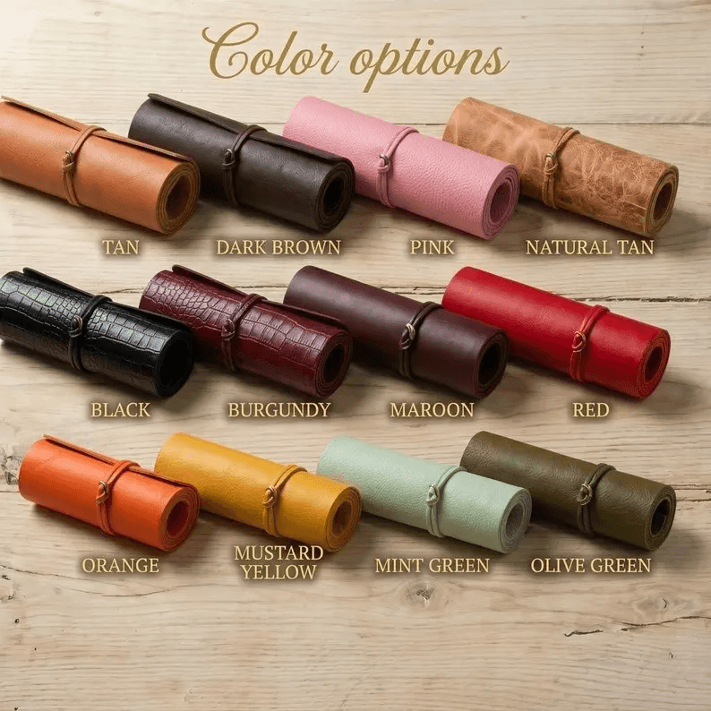 A display of twelve premium leather color options for the luxury pet carry bag, including Tan, Black, Burgundy, Mint Green, and Mustard Yellow, shown as rolled material samples on a wooden surface.