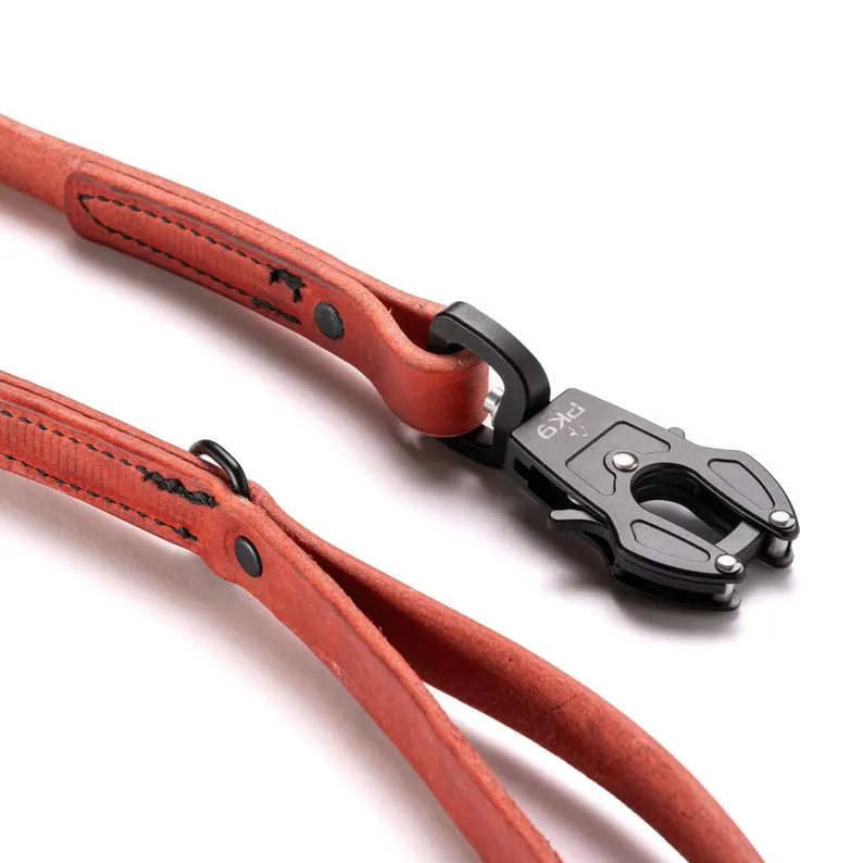 Leather Dog Leash | Aussie Red Hide with Quick-Release Frog Clip A detailed macro shot of the reinforced black stitching and metal rivet construction on a red leather dog leash, emphasizing the durability of the hardware.