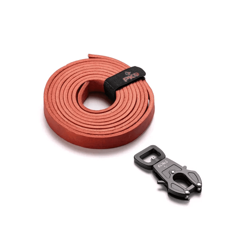 Leather Dog Leash | Aussie Red Hide with Quick-Release Frog Clip A close-up overhead shot of a coiled red leather dog leash secured with a black "PK9" branded strap, featuring a heavy-duty metal frog clip connector.