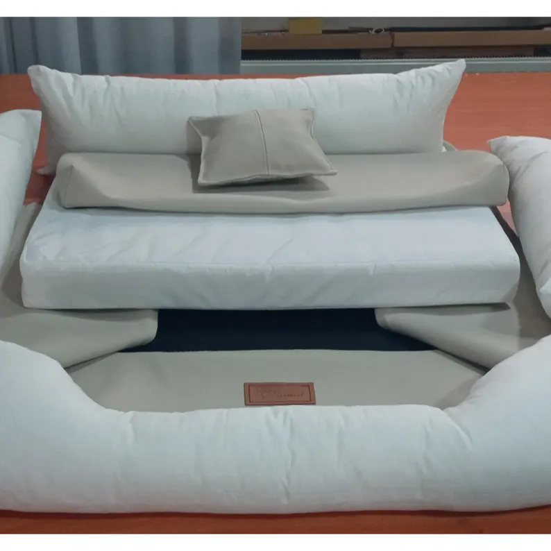 Leather Dog Bed | Luxury Handmade Pet Sofa Overhead view of the disassembled leather dog bed components, showing the thick white internal orthopedic foam mattress and the separate bolstered leather covers.