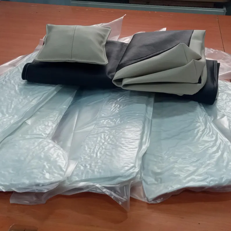 Leather Dog Bed | Luxury Handmade Pet Sofa Close-up of the leather dog bed materials being prepared, featuring the folded vegan leather covers in grey and black and the vacuum-sealed internal padding.