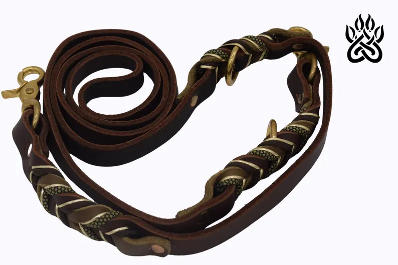 Leather Dog Leash | Full Grain Leather Lead Braided Studio shot of a premium Leather Dog Leash displaying its modular design. The dark leather strap includes several brass O-rings and decorative woven sections, shown against a clean white background with a stylized paw logo in the corner.