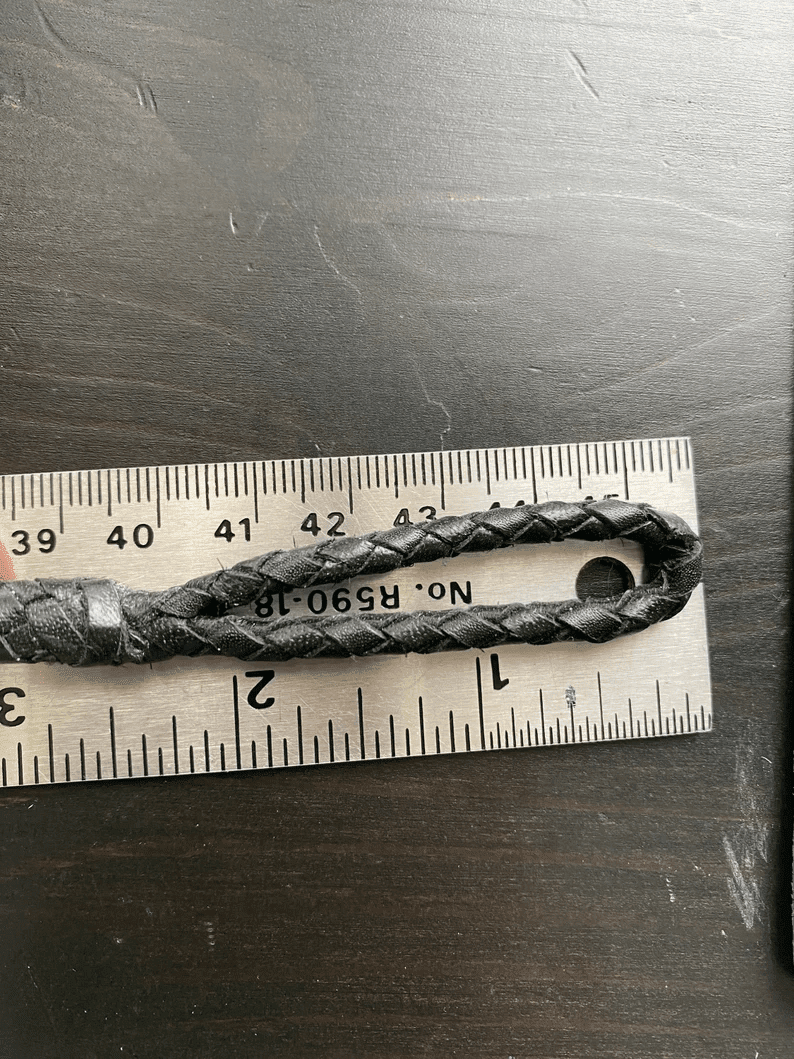 Leather Dog Leash | Braided Kangaroo Leather Dog Show Lead A close-up of the leash’s handle loop placed against a metal ruler. The braided leather loop is approximately 2 inches long, showing the tight weave and reinforced leather binding at the base.