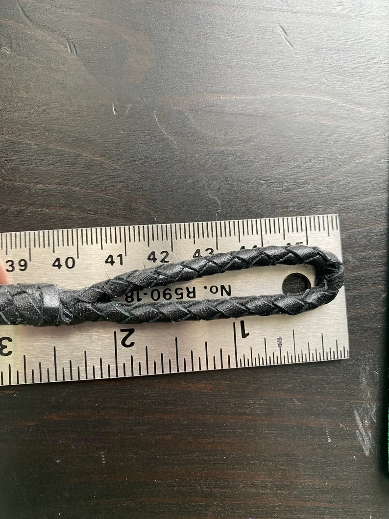 Leather Dog Leash | Braided Kangaroo Leather Dog Show Lead A close-up of the leash’s handle loop placed against a metal ruler. The braided leather loop is approximately 2 inches long, showing the tight weave and reinforced leather binding at the base.